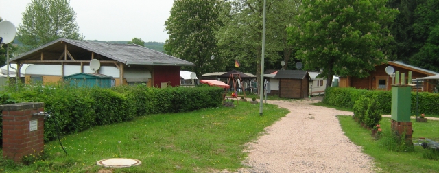 the campsite at lebach showing scruffy outbuildings and shelters over caravans